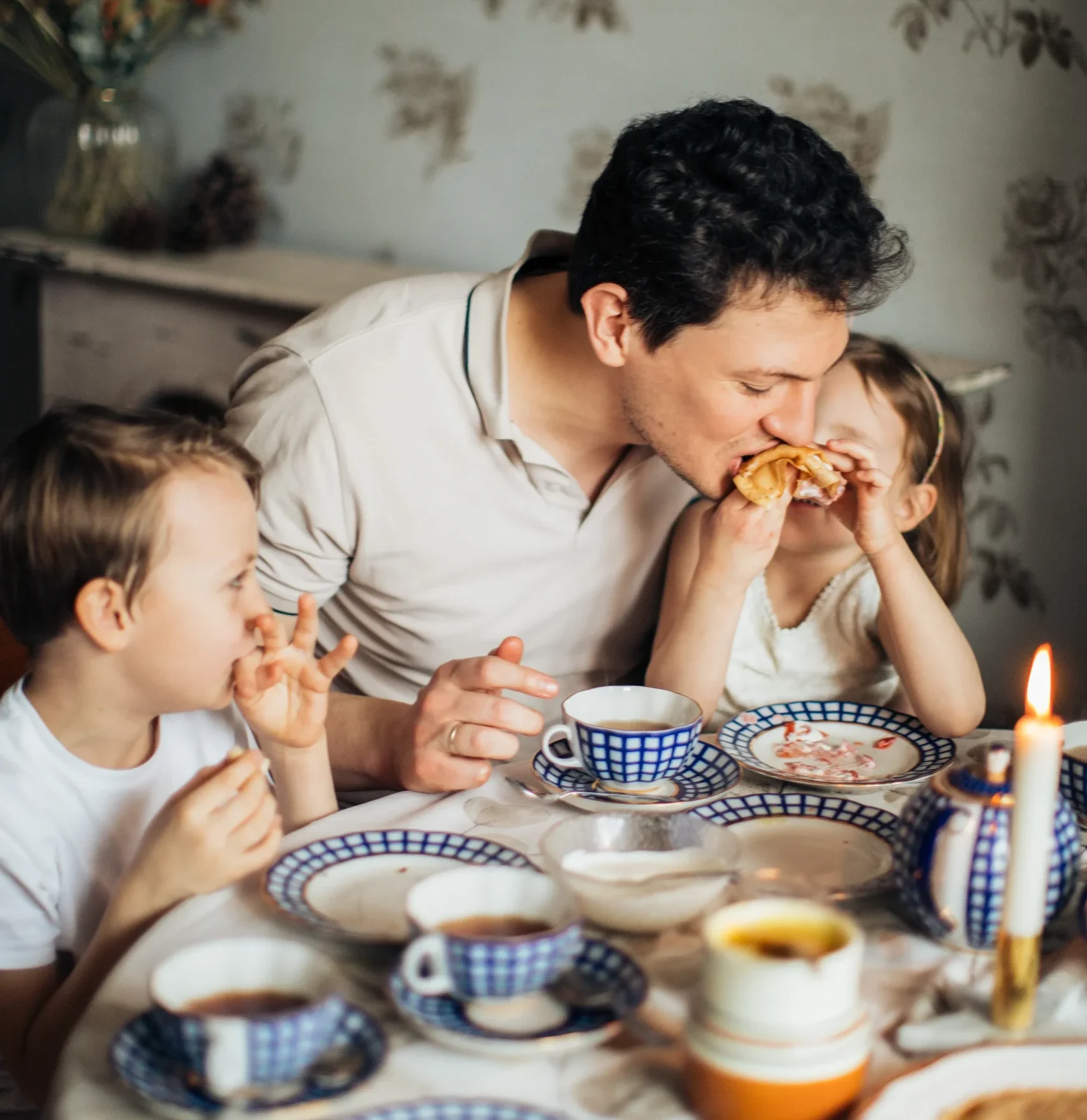 Father having breakfast with two children. 