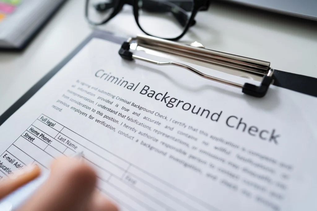 A criminal background check form on a clipboard.